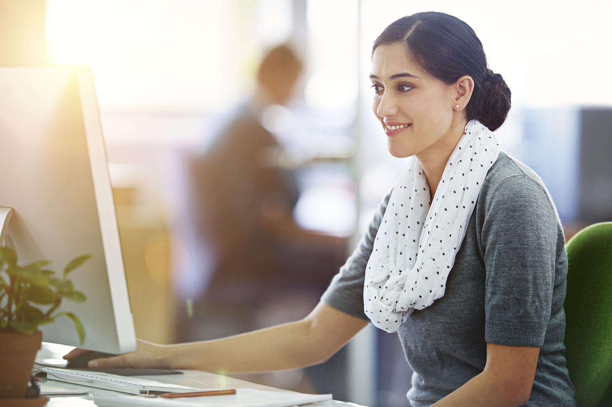 Woman at computer using Retail Management Intelligence