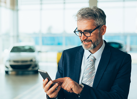 Dealership employee using phone for timekeeping and attendance records