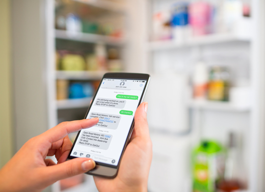 Person viewing message from dealership using Text Messaging for ERA