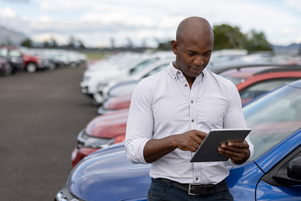 Man on dealership lot using AutoVision on a tablet
