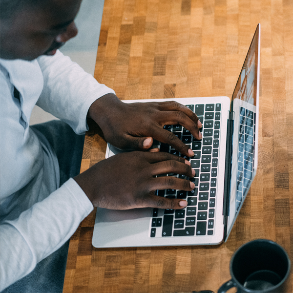 Young man working on a computer, completing his career assessment.