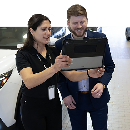 Image of a service representative on a tablet with a customer