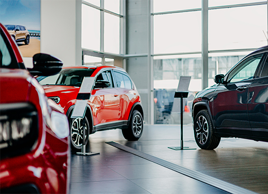 Dealership showroom with red cars